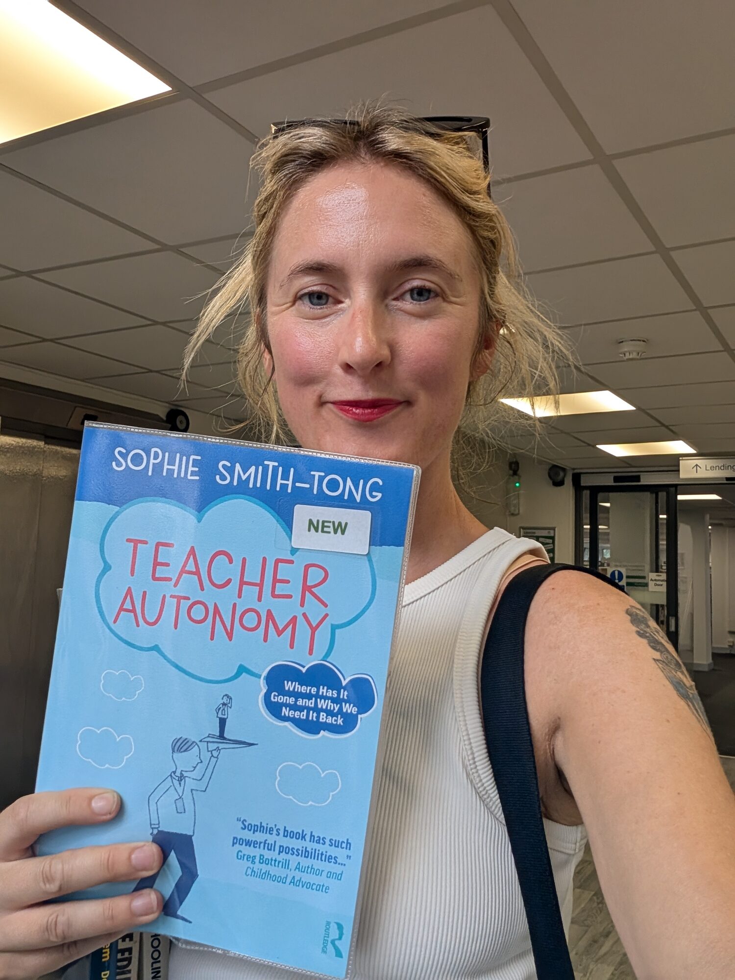 Sophie holding a copy of Teacher Autonomy