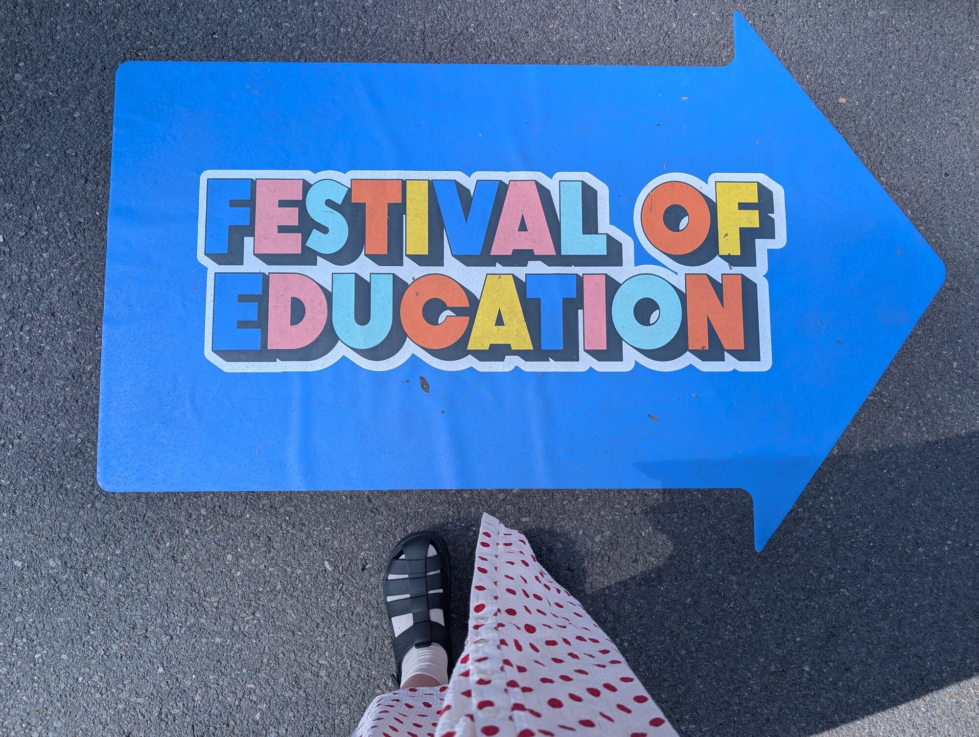 Festival of Education arrow sign painted on the ground