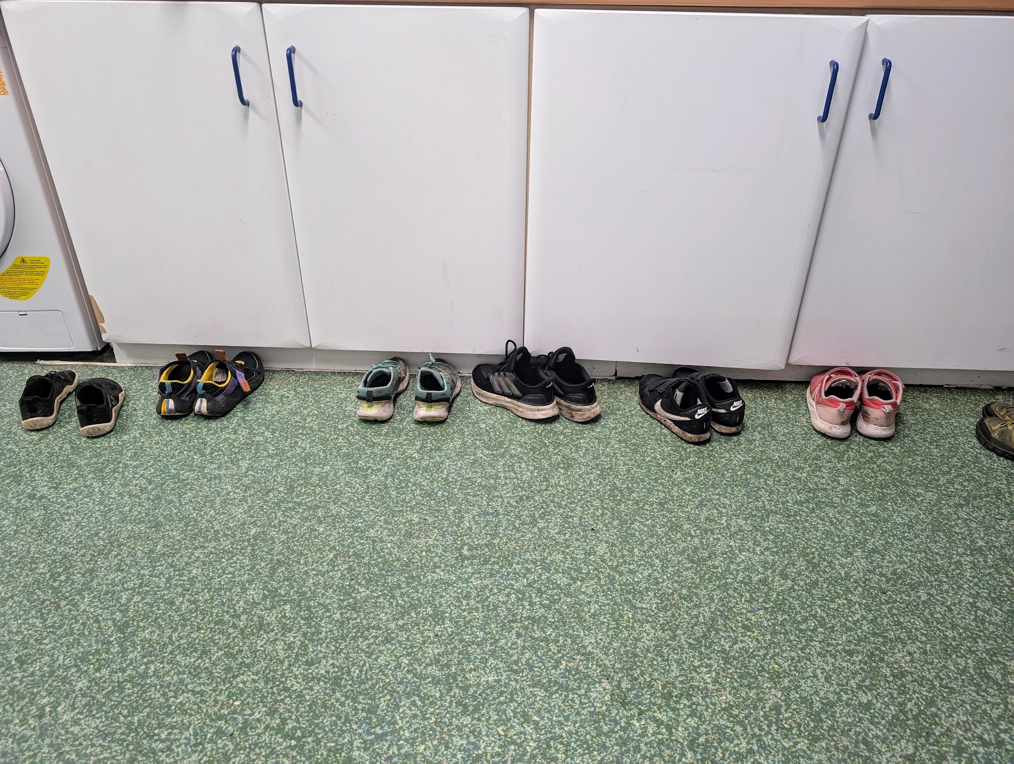 Children removing their shoes for comfort in the library